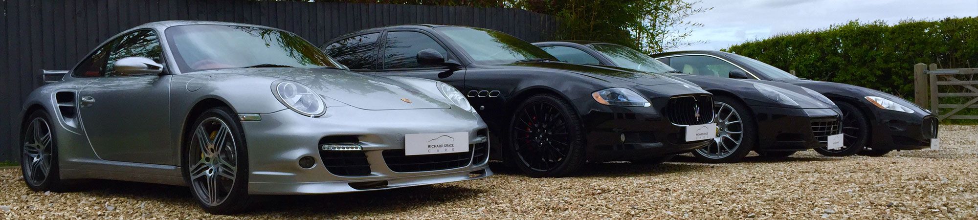 Lineup of Maserati and Porsche vehicles at Richard Grace Cars